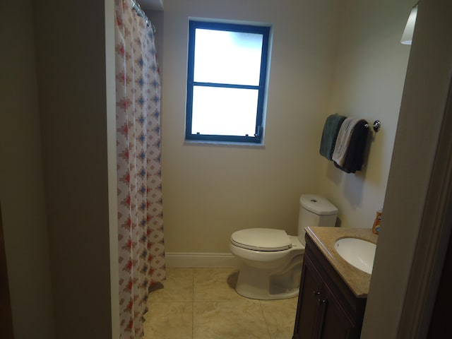 bathroom with a shower with curtain, tile patterned flooring, vanity, and toilet