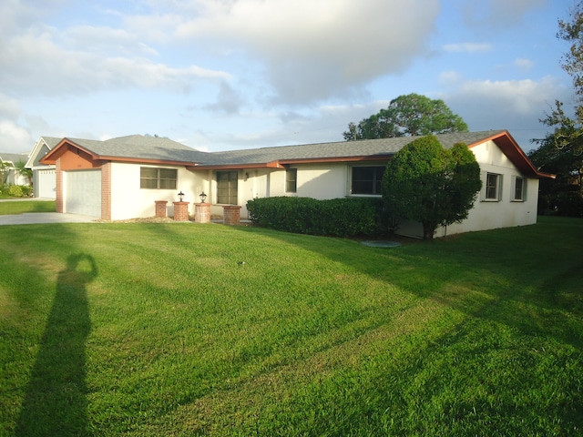 single story home with a garage and a front yard