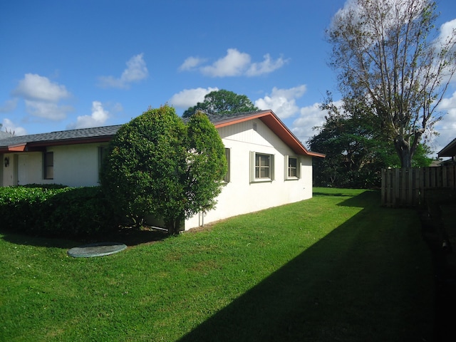 view of side of property featuring a yard