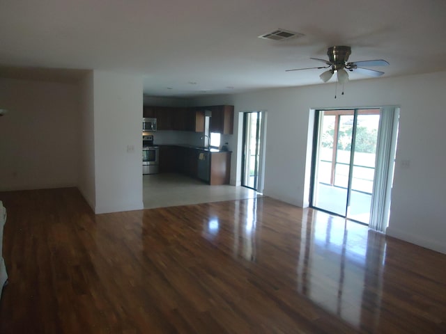 unfurnished living room featuring wood-type flooring and ceiling fan