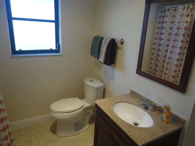 bathroom featuring tile patterned floors, vanity, and toilet