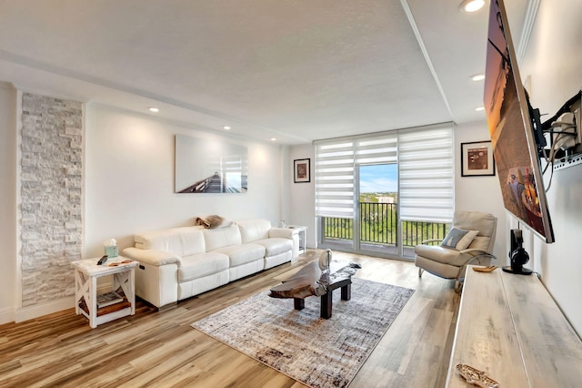 living room featuring floor to ceiling windows and light wood-type flooring