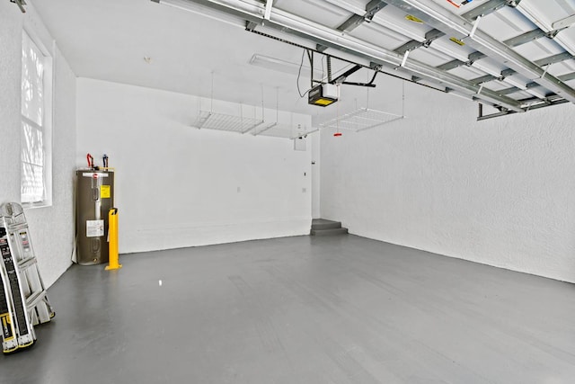 garage featuring electric water heater and a garage door opener