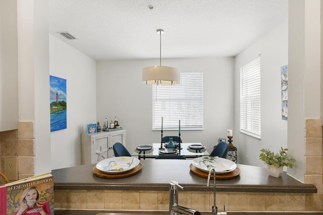 interior space with a textured ceiling and visible vents