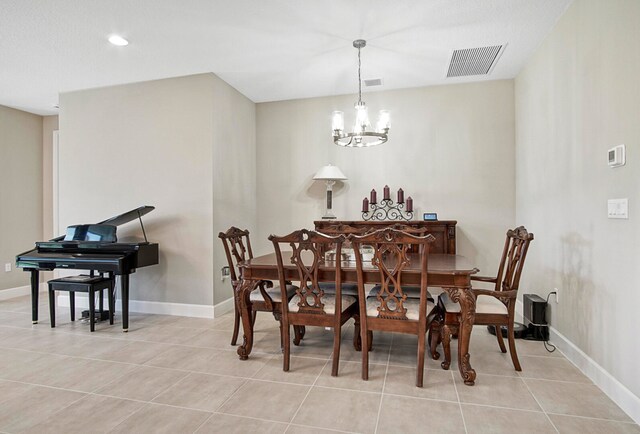 dining room featuring a chandelier and light tile patterned floors