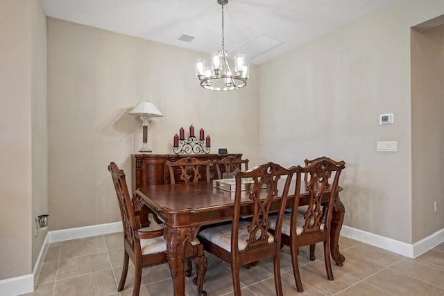 dining room featuring light tile patterned flooring and an inviting chandelier