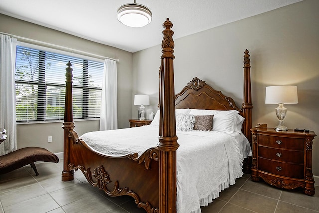 bedroom with tile patterned floors and baseboards