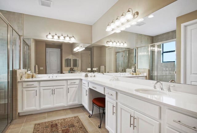 bathroom featuring vanity, walk in shower, and tile patterned flooring