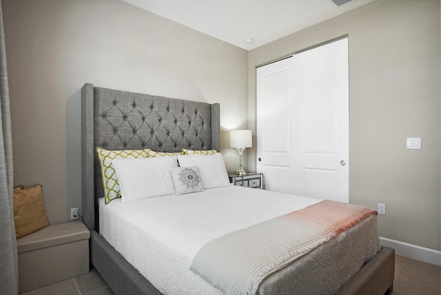 tiled bedroom with a closet