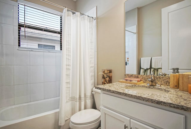 full bathroom with toilet, shower / tub combo with curtain, and vanity