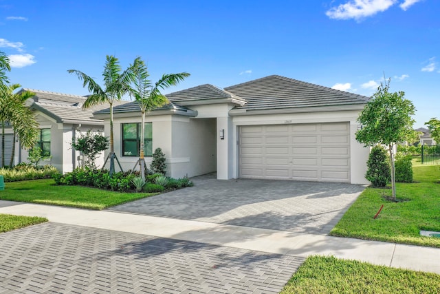 single story home featuring a front lawn and a garage