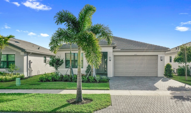 view of front of home with a front yard and a garage