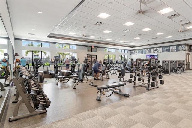 exercise room featuring a paneled ceiling and a tray ceiling