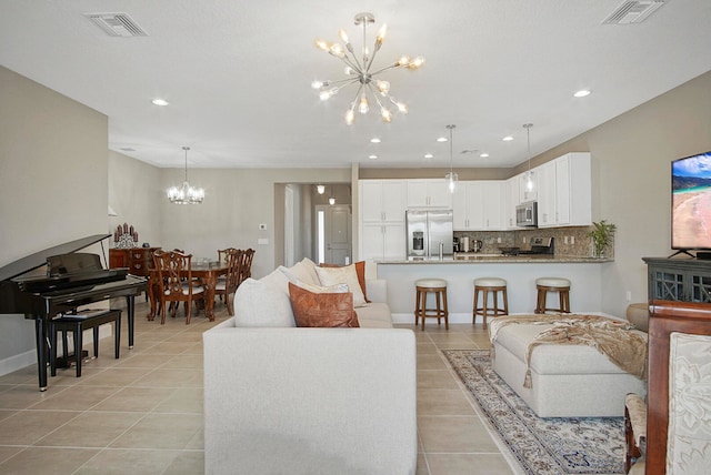 living room featuring a notable chandelier and light tile patterned floors