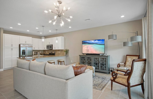 living room featuring a chandelier and light tile patterned floors