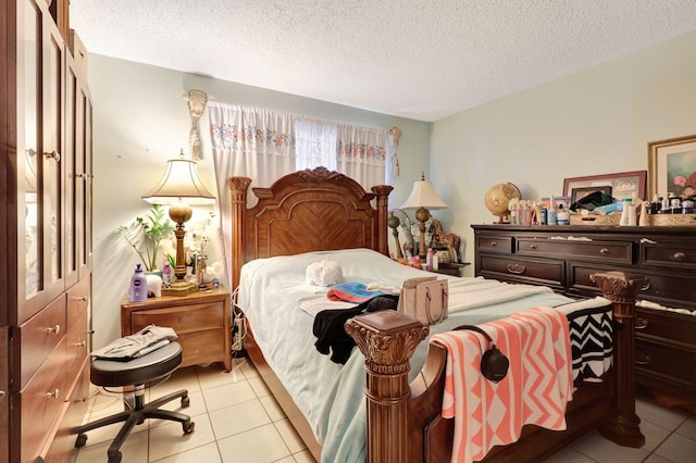 bedroom featuring a textured ceiling and light tile patterned floors