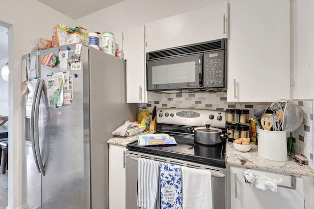 kitchen featuring light stone countertops, appliances with stainless steel finishes, decorative backsplash, and white cabinets