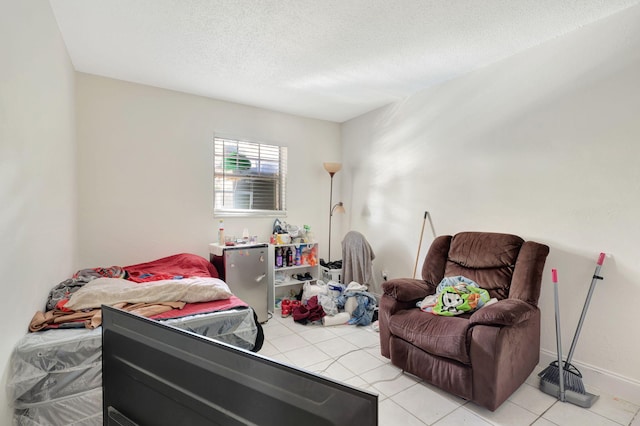 tiled bedroom featuring a textured ceiling