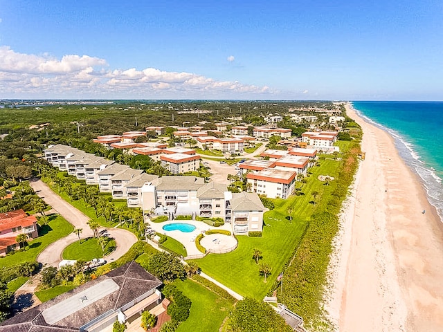 aerial view with a water view and a beach view