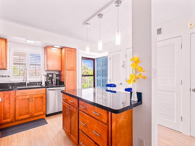 kitchen with tasteful backsplash, light hardwood / wood-style flooring, dishwasher, decorative light fixtures, and sink