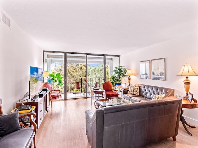 living room featuring light hardwood / wood-style floors and floor to ceiling windows