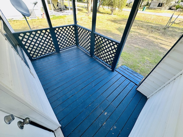 wooden deck featuring a lawn