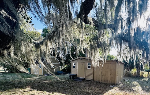 exterior space featuring a shed and an outbuilding