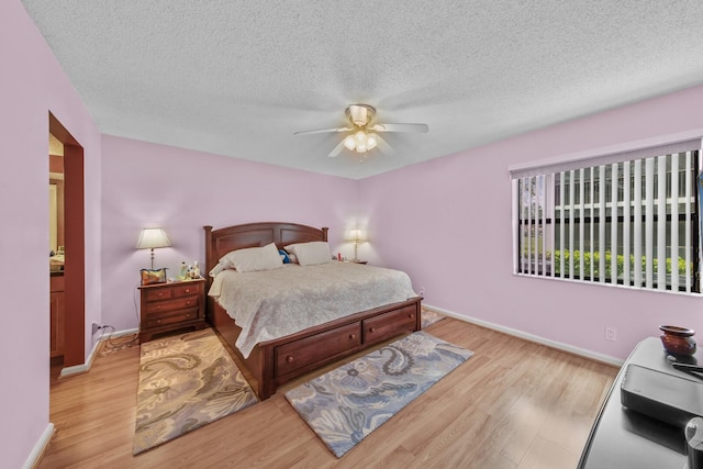 bedroom featuring ceiling fan, a textured ceiling, and light hardwood / wood-style flooring