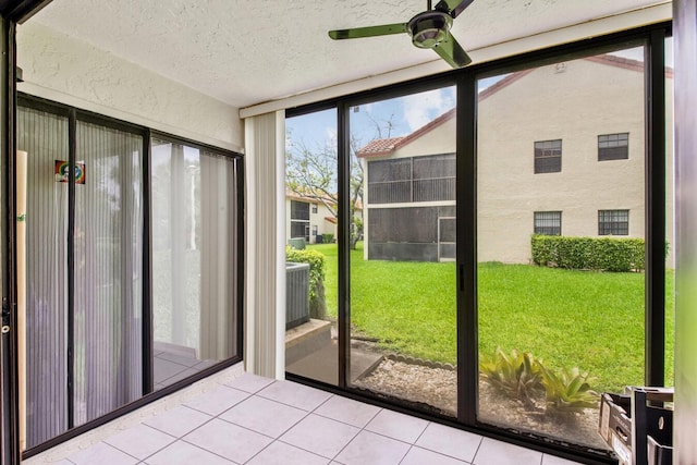 unfurnished sunroom featuring ceiling fan