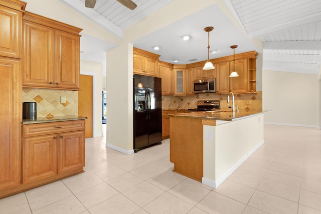 kitchen featuring decorative light fixtures, lofted ceiling with beams, dark stone counters, and appliances with stainless steel finishes