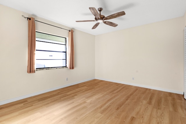 empty room with ceiling fan and light hardwood / wood-style flooring