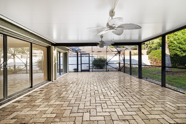 unfurnished sunroom with ceiling fan