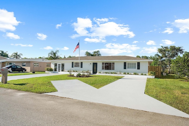 single story home featuring a front yard