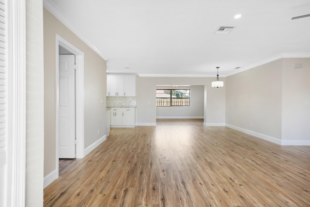 unfurnished living room with light hardwood / wood-style flooring, ornamental molding, and ceiling fan