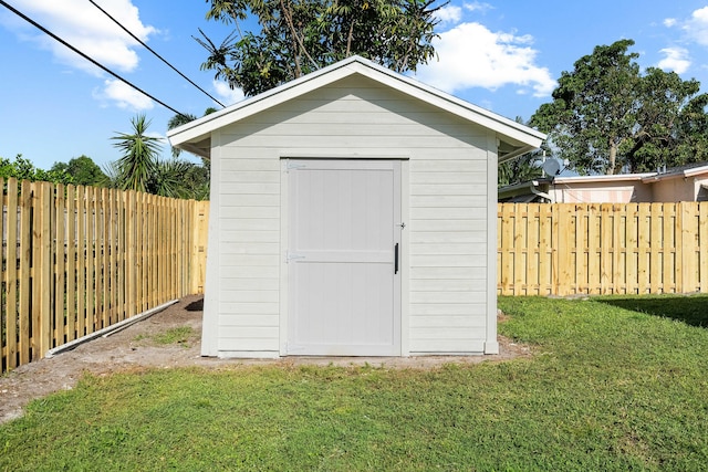 view of outbuilding with a yard