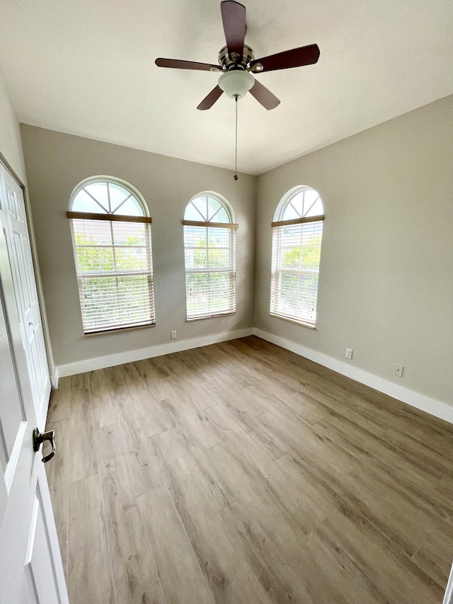 spare room with light hardwood / wood-style flooring and ceiling fan