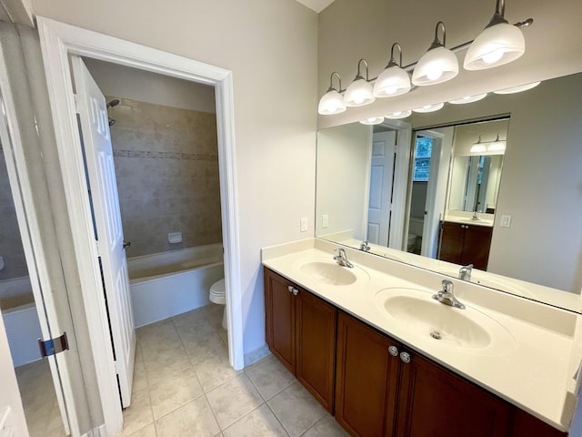 full bathroom with vanity, tiled shower / bath combo, toilet, and tile patterned floors