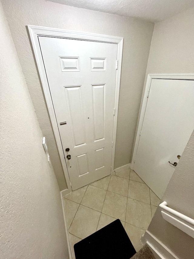 entryway with light tile patterned floors