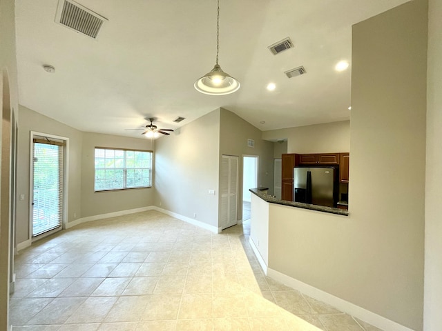 interior space with ceiling fan and vaulted ceiling