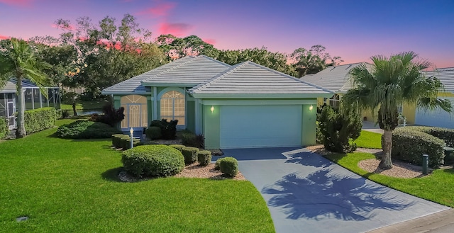 view of front of property with a yard and a garage