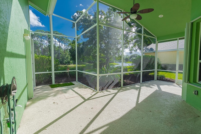 unfurnished sunroom with vaulted ceiling and ceiling fan