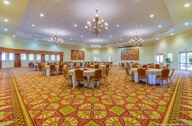 dining area with crown molding, light colored carpet, a raised ceiling, and a high ceiling