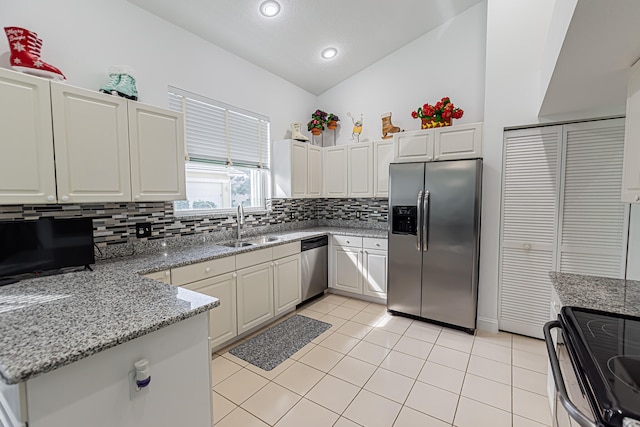 kitchen with light tile patterned floors, sink, stainless steel appliances, tasteful backsplash, and light stone countertops