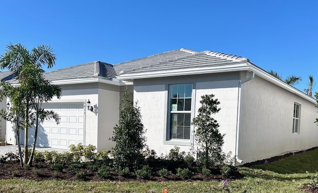 view of side of home featuring a garage