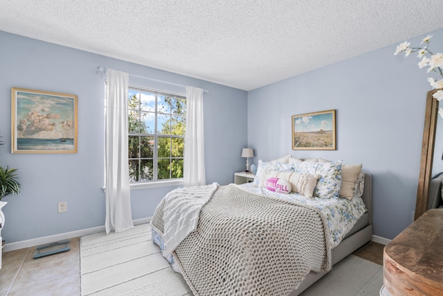 tiled bedroom with a textured ceiling