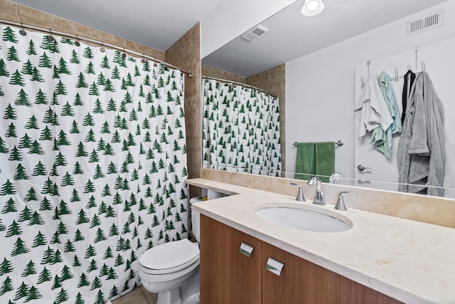 bathroom with vanity, a shower with shower curtain, and toilet