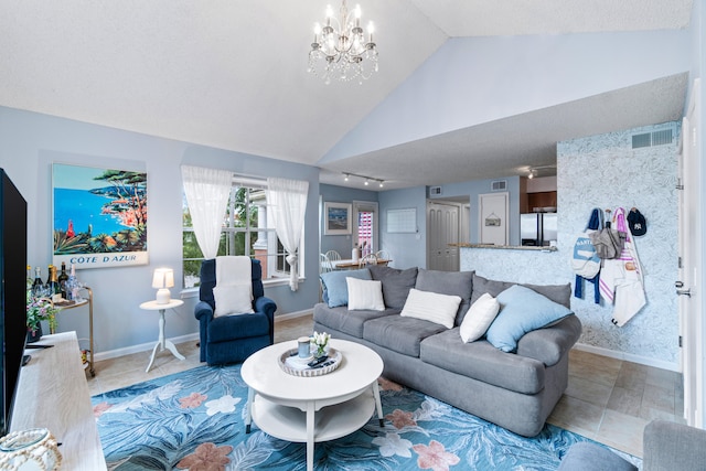 tiled living room featuring lofted ceiling and a chandelier