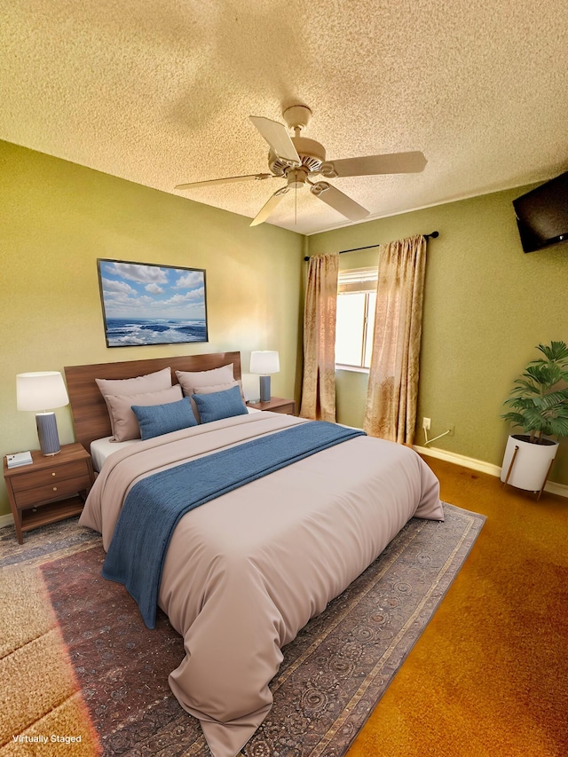 carpeted bedroom with ceiling fan and a textured ceiling