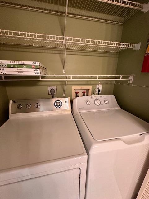 clothes washing area with independent washer and dryer