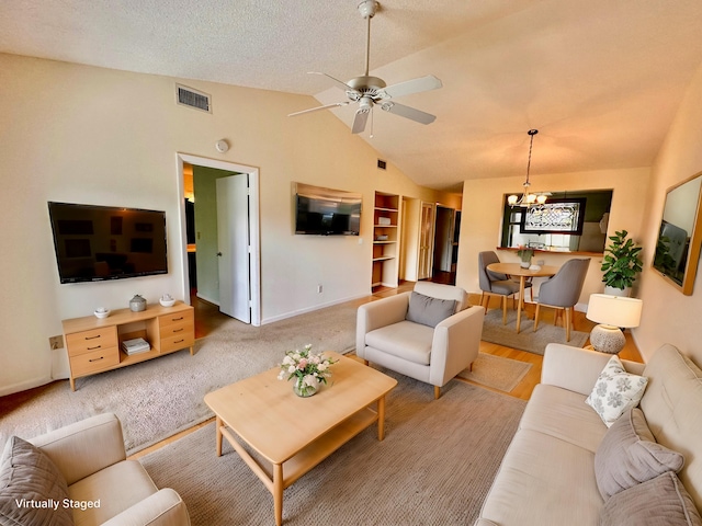 living room featuring ceiling fan and vaulted ceiling